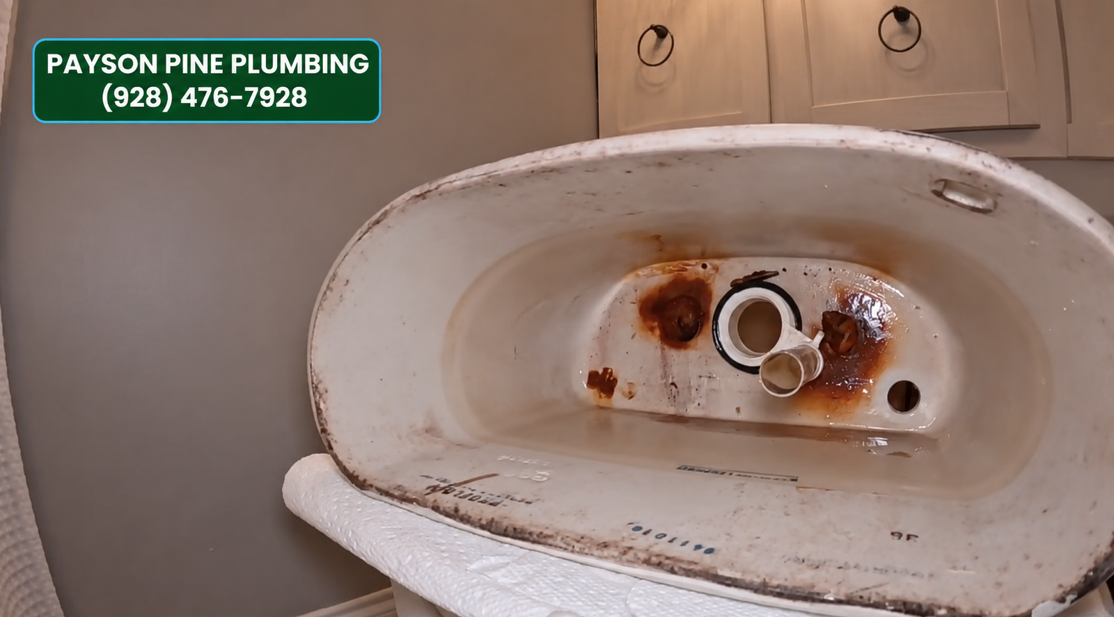 Old corroded toilet tank removed during a fixture replacement